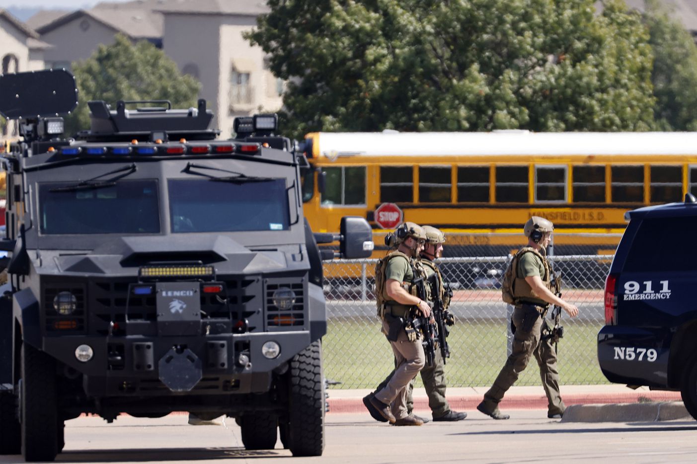 Tactical officers clear the scene following a shooting inside Mansfield Timberview High...