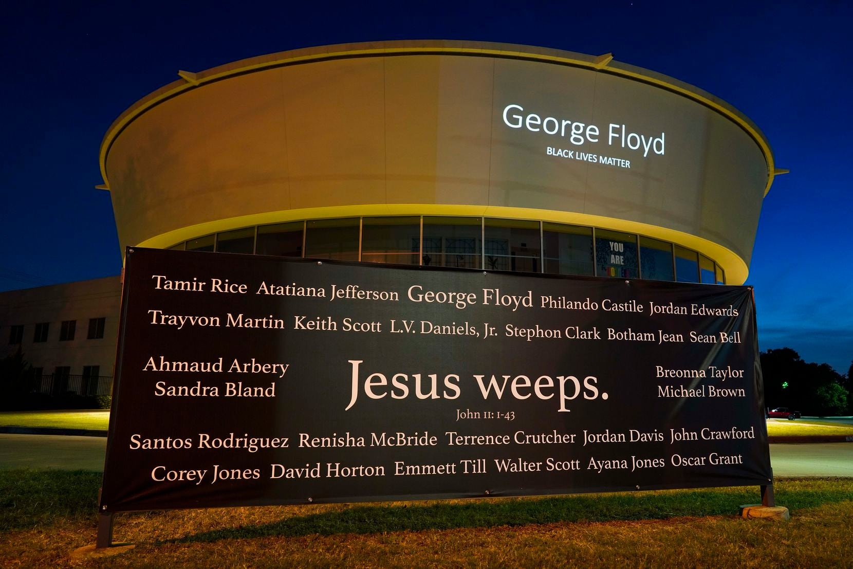 A banner reading "Jesus weeps: bearing the names of Black people killed by police or other...