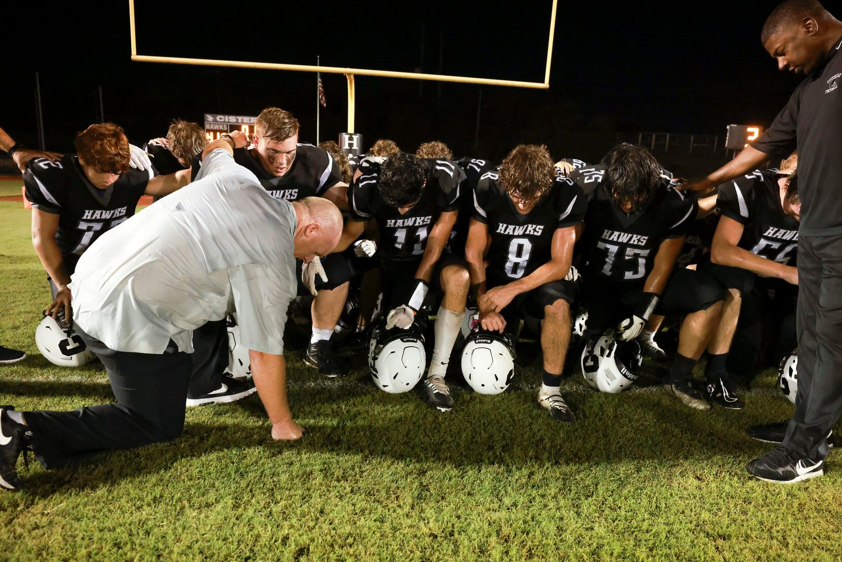 Cistercian Preparatory School players with head coach James Burk and pray after winning the...