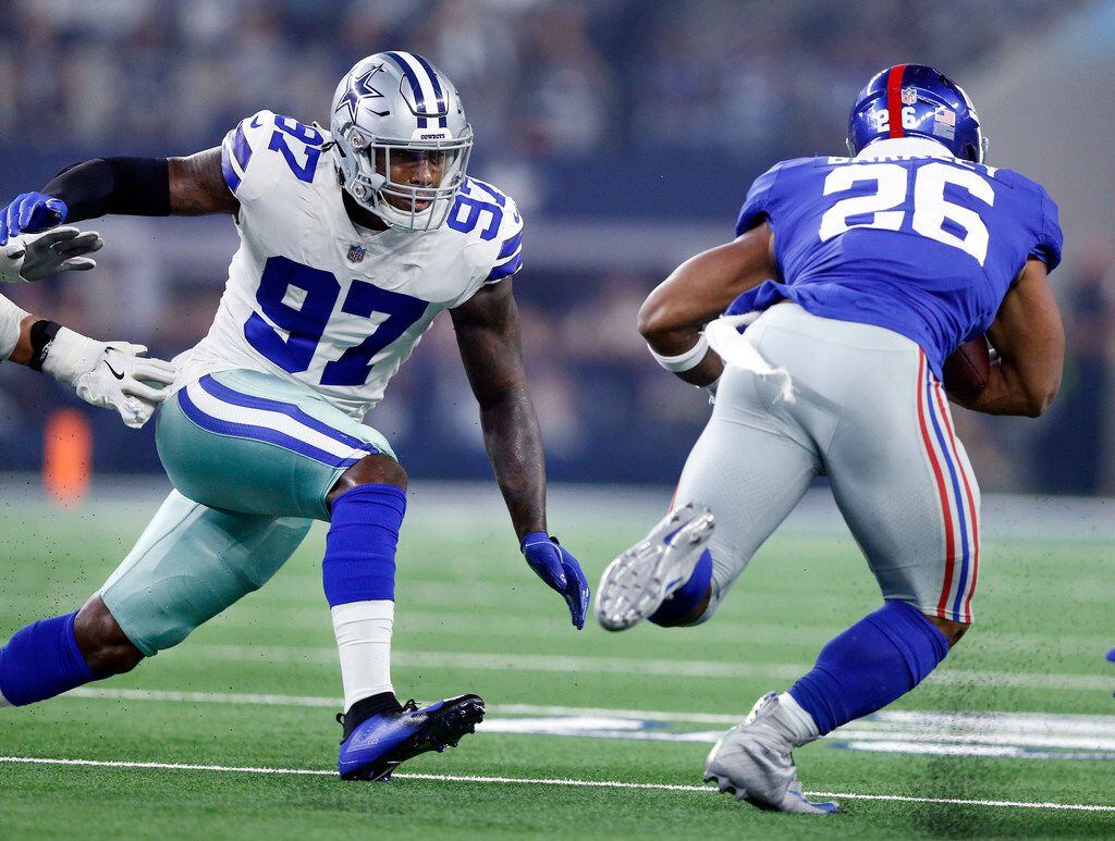 Dallas Cowboys defensive end Taco Charlton (97) gives pursuit to New York Giants running back Saquon Barkley (26) during the first quarter at AT&T Stadium in Arlington, Texas, Sunday, September 16, 2018. (Tom Fox/The Dallas Morning News)
