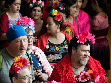 Dozens of Frida look-alikes stand in line at the Dallas Museum of Art during an attempt to...