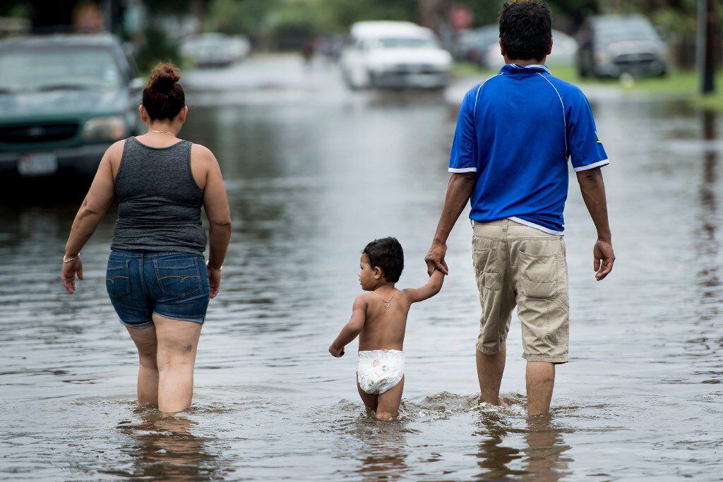 People walk through flooded streets as the effects of Hurricane Henry are seen August 26, 2017 in Galveston, Texas.
Hurricane Harvey left a trail of devastation Saturday after the most powerful storm to hit the US mainland in over a decade slammed into Texas, destroying homes, severing power supplies and forcing tens of thousands of residents to flee.