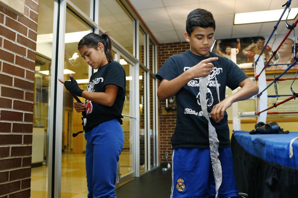  Candice Badillo, 11, (left) and Oliver Badillo, 13, wrap their wrists before practice with...