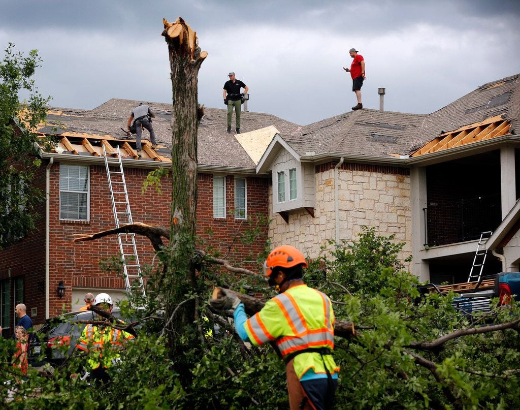 It was a hub of activity on Oliver Drive in the north part of Fort Worth as crews covered damaged rooftops and disposed of splintered trees on Wednesday. A strong storm passed through the neighborhood near Heritage Trace Parkway and North Riverside Drive.