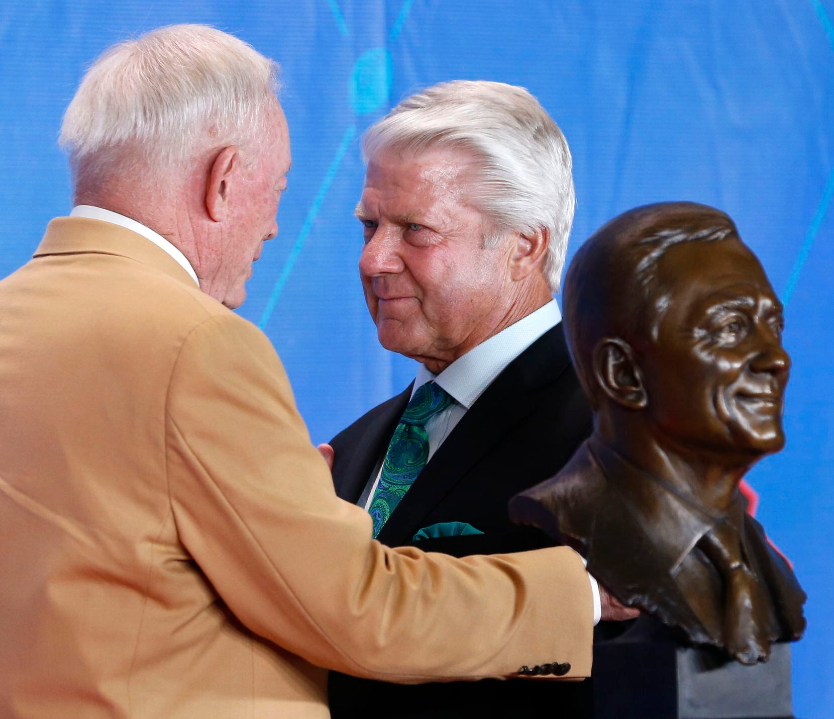 Former Dallas Cowboys head coach Jimmy Johnson listens as 2017 Pro Football Hall of Fame inductee and Dallas Cowboys owner and general manager Jerry Jones talks to him at the 2017 Pro Football Hall of Fame Enshrinement Ceremony at Tom Benson Stadium in Canton, Ohio on Saturday, August 6, 2017.