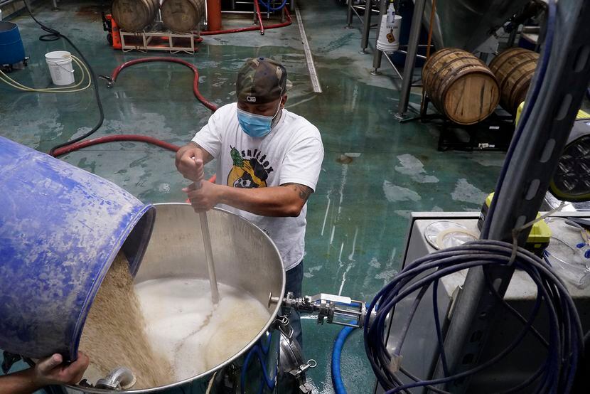 Kuumba Smith mashes the grain for a kettle sour beer at Hop & Sting Brewing Co. in Grapevine.