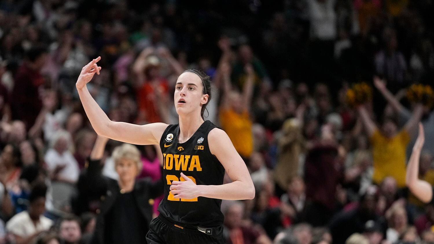 Iowa's Caitlin Clark reacts after a three pointer during the second half of an NCAA Women's...