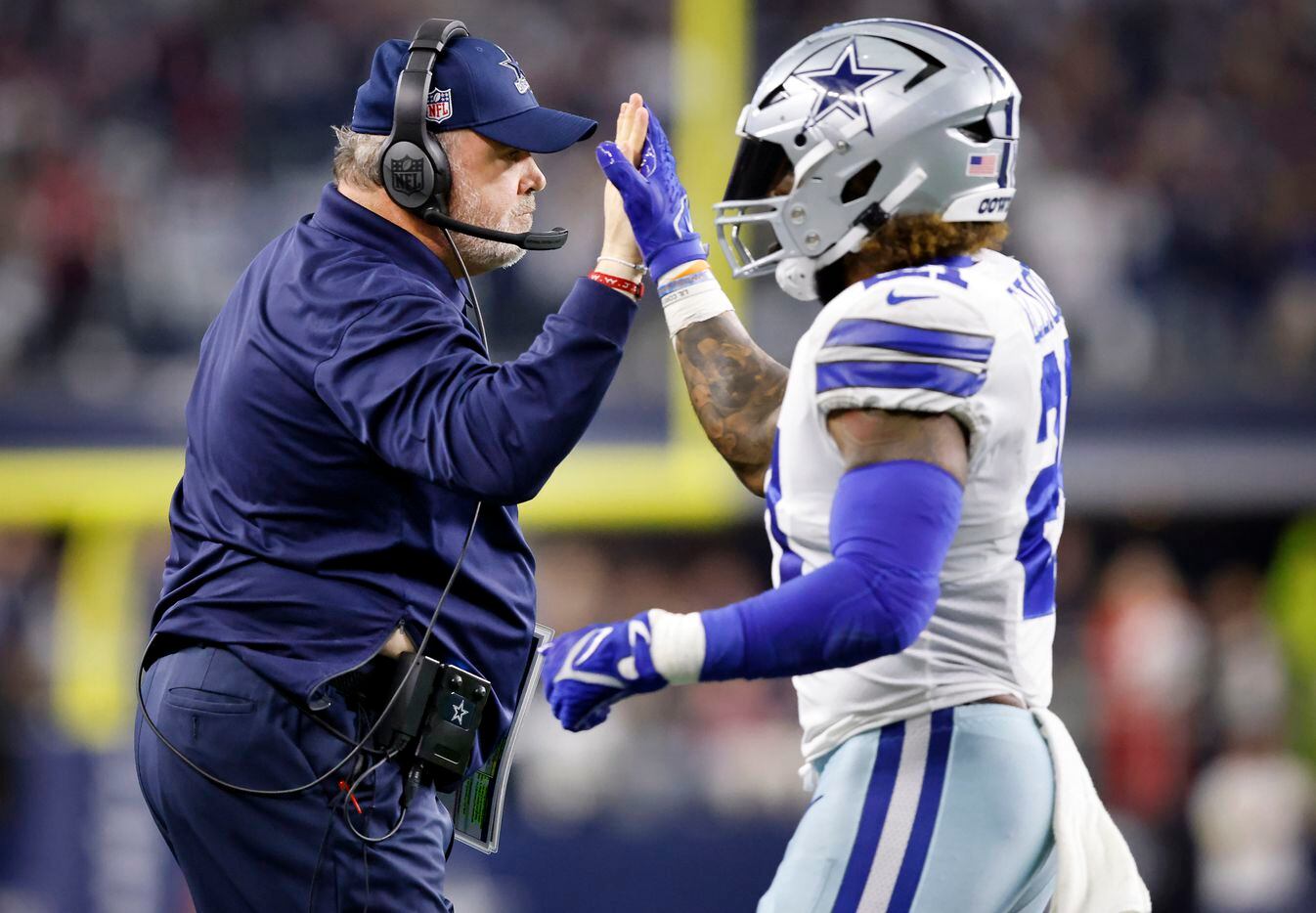 Dallas Cowboys head coach Mike McCarthy slaps hands with Dallas Cowboys running back Ezekiel...
