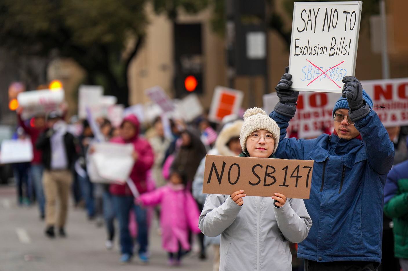 Demonstrators march in opposition to Texas Senate Bills 147 and 552 on Sunday, Jan. 29,...