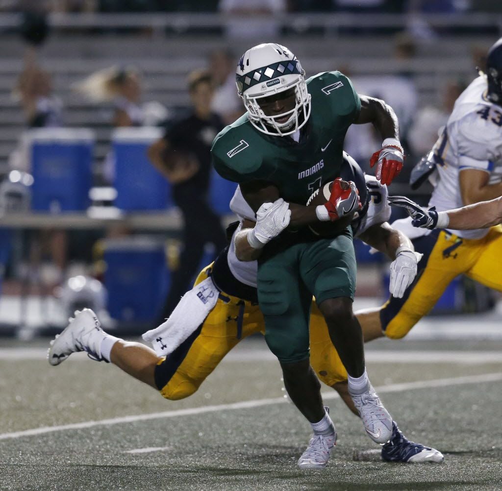FILE - Waxahachie receiver Jalen Reagor (1) is tackled by Highland Park defensive player...