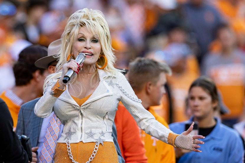 Dolly Parton performs during the first half of an NCAA college football game between...