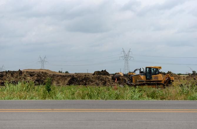 
Construction workers move dirt for a 1,400-home development called Inspiration.
