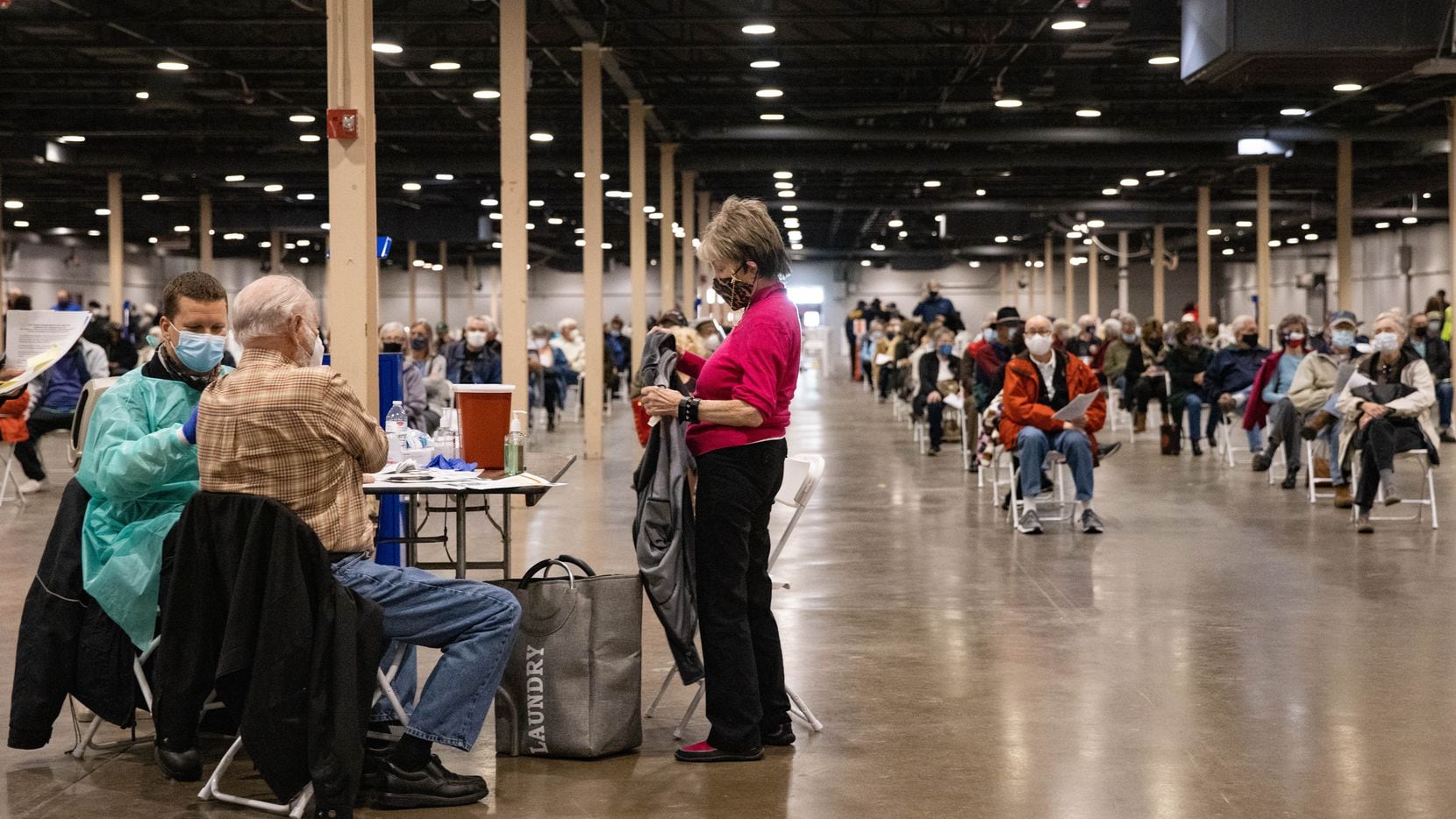 People wait to receive the COVID-19 vaccine at Fair Park in Dallas on Thursday, Jan. 14, 2021. (Juan Figueroa/ The Dallas Morning News)