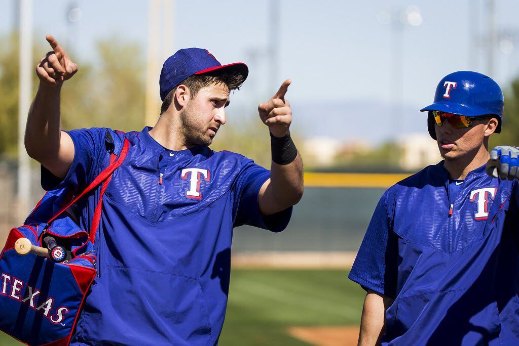 Texas Rangers outfielder Joey Gallo (right) talks with infielder Drew Robinson during a...