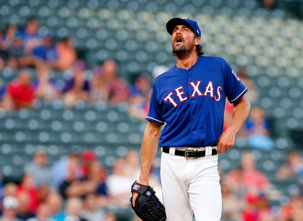 Rangers pitcher Cole Hamels (35) takes a moment on the mound as he gets off to a rough start...