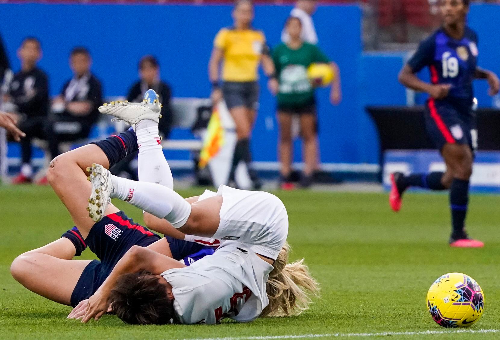 Japan forward Mina Tanaka (15) collides with USA midfielder Lindsey Horan (9) for a penalty...