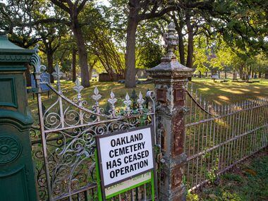 A sign warns visitors that the Oakland Cemetery is no longer operating. It has caught...