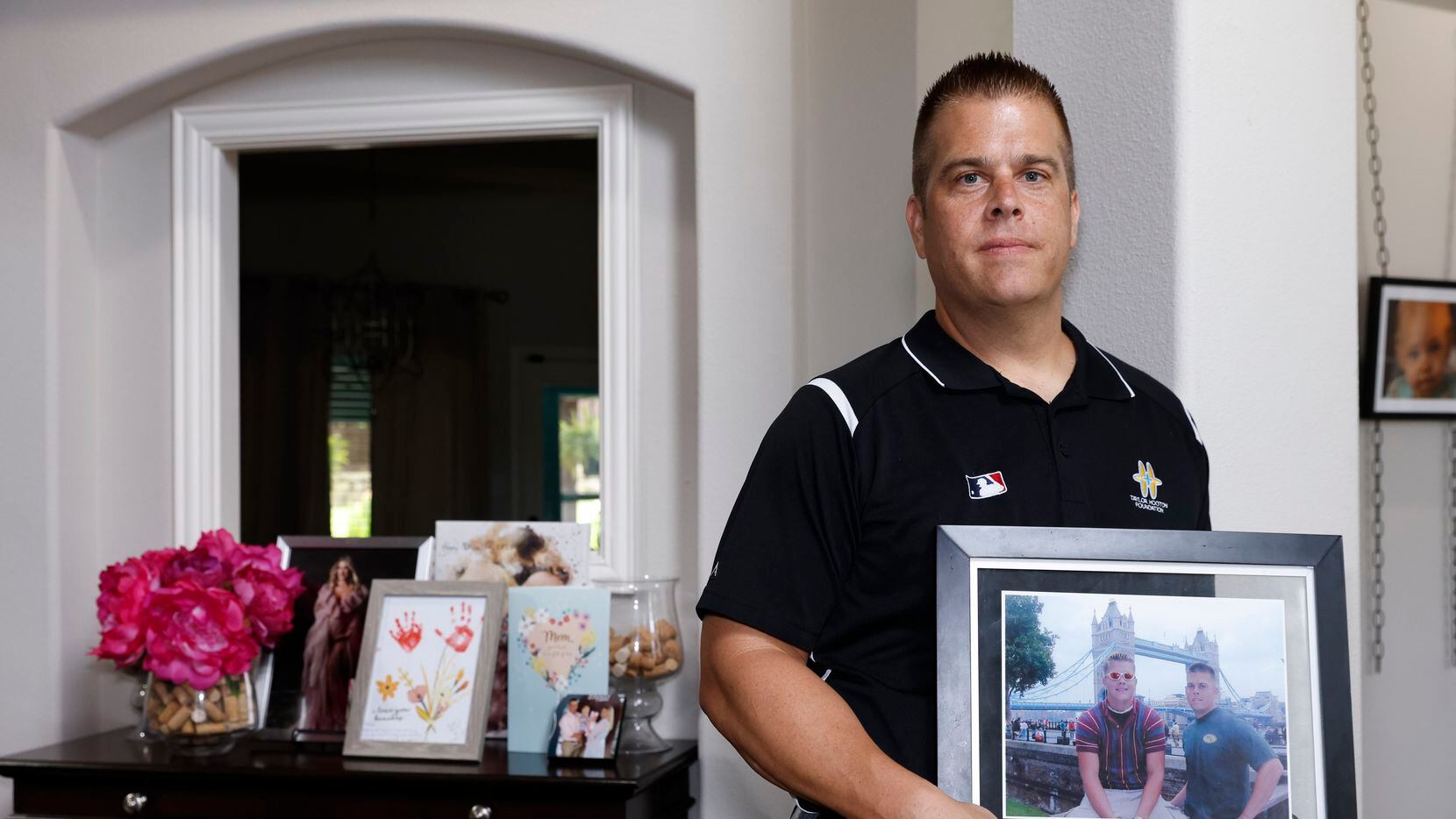 Donald Hooton, brother of Taylor Hooton, poses for a portrait with a framed photo of them on...