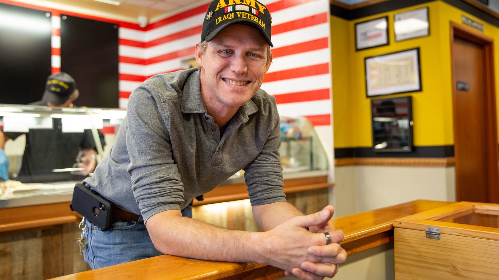 David Jordan, shop owner and previously homeless veteran, poses for a portrait at Patriot...