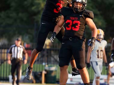 Euless Trinity running back Garry Maddox (3) celebrates his touchdown against Arlington...
