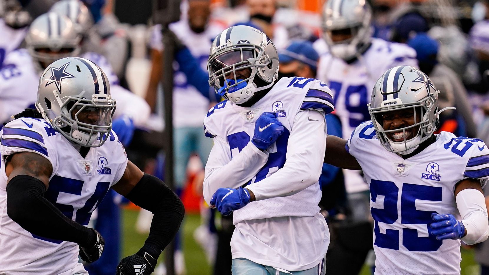 Dallas Cowboys cornerback Rashard Robinson, center celebrates a defensive stop against the Cincinnati Bengals with free safety Xavier Woods (25) and middle linebacker Jaylon Smith (54) in the second half of an NFL football game in Cincinnati, Sunday, Dec. 13, 2020.