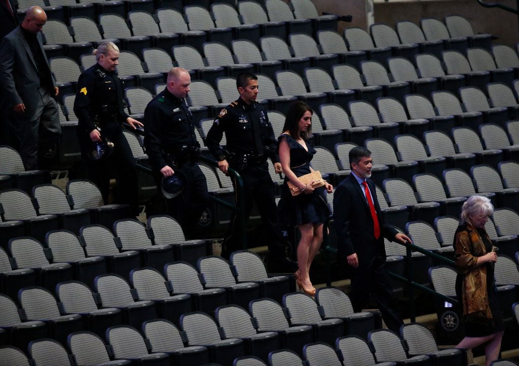 Dallas officers and their families walk onto the arena floor during the "Night of Honor"...