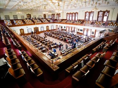 Democrats gathered around the podium as they spoke in opposition to Senate Bill 7 in the House Chamber at the Texas Capitol during the 87th Texas Legislature on May 7, 2021.