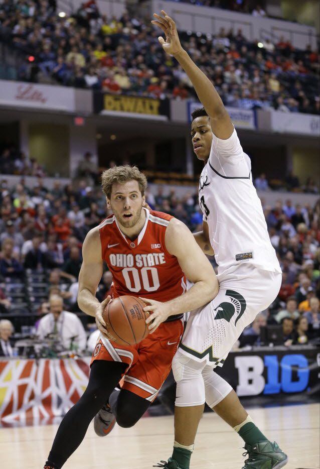 Ohio State's Mickey Mitchell (00) drives past Michigan State's Deyonta Davis (23) during the...