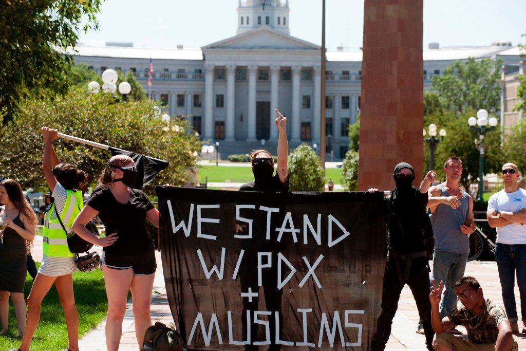 Anti-Trump demonstrators taunt counter-demonstrators during the Denver March Against Sharia...