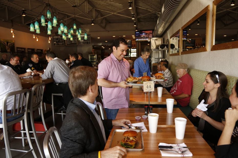 Kevin Galvan serves burgers to lunchtime customers at Haystack Burgers and Barley in...