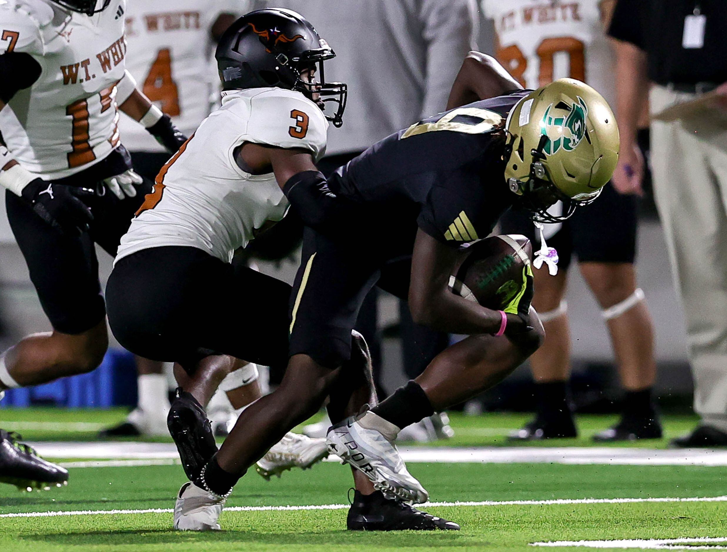 Birdville wide receiver Brian Kent (9) is stopped by W.T. White defensive back Lekylon...