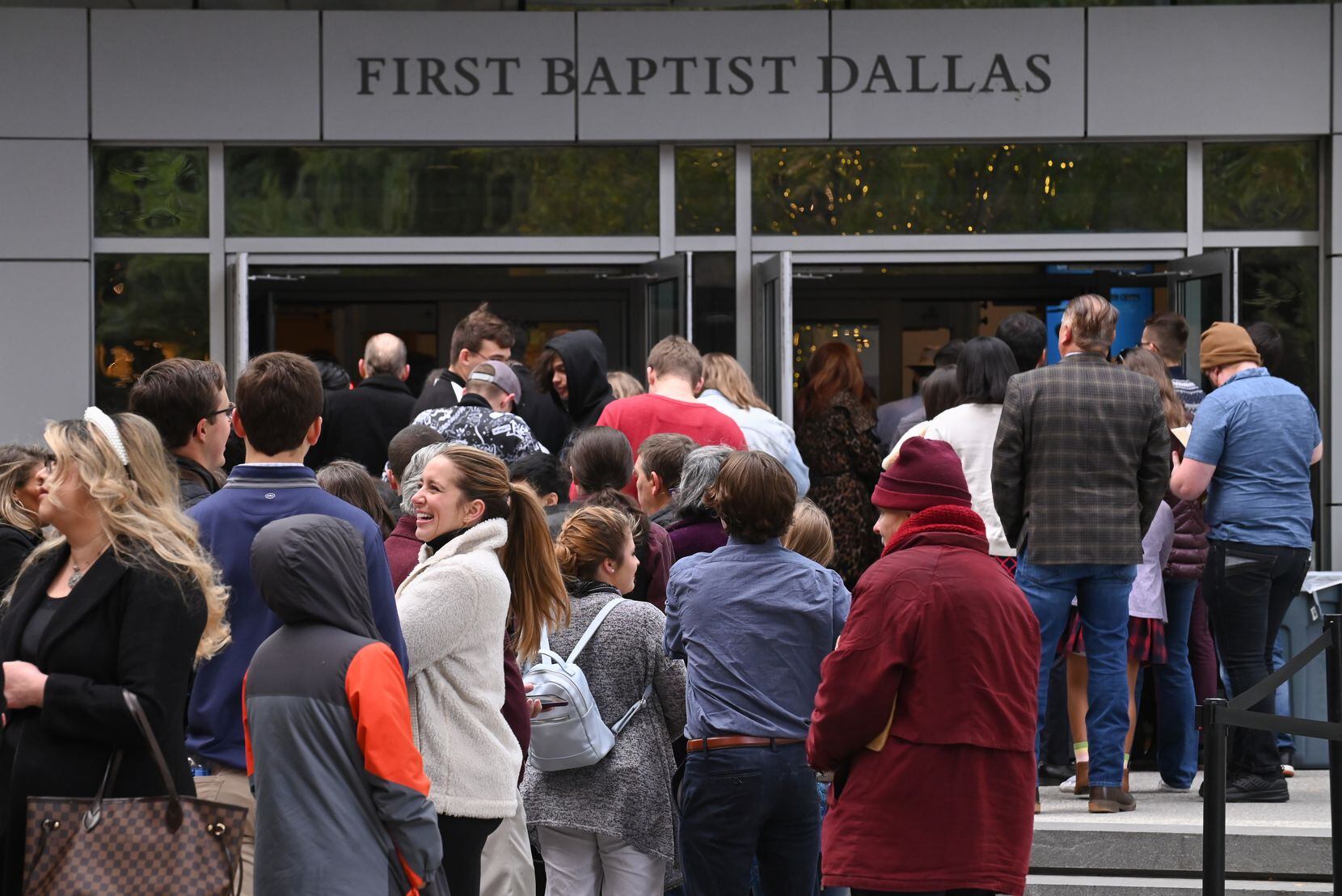 Trump supporters and church members of First Baptist Dallas wait in line for Sunday morning...