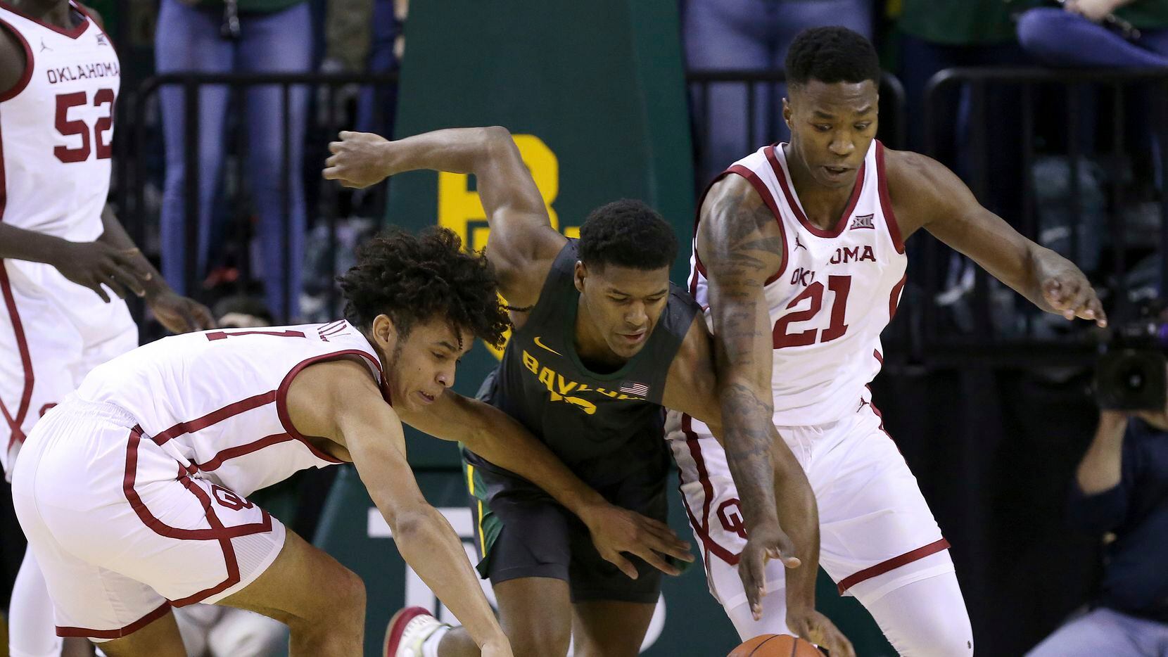 Oklahoma forward Jalen Hill (1) Baylor guard Jared Butler (12) and Oklahoma forward Kristian Doolittle (21) reach for the loose ball in the first half of an NCAA college basketball game Monday, Jan. 20, 2020, in Waco, Texas.