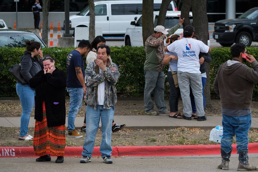 People react outside CVE Group after a bus from LaSalle Corrections Transport departed the facility on Wednesday, April 3, 2019, in Allen.