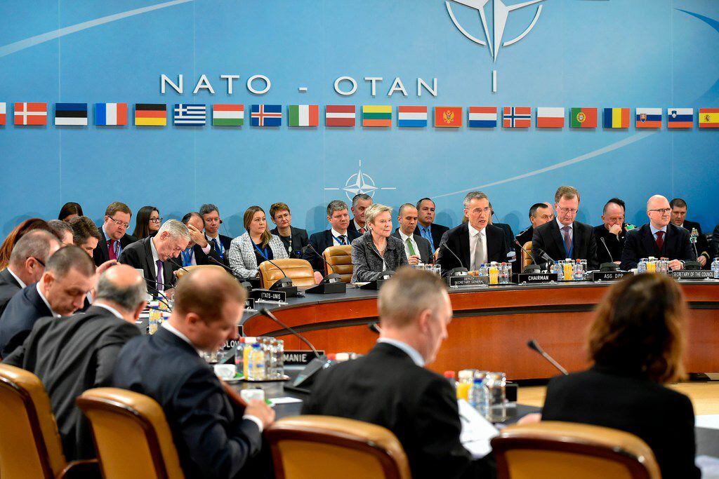 NATO Secretary-General Jens Stoltenberg (C) speaks during a meeting on the second day of the...