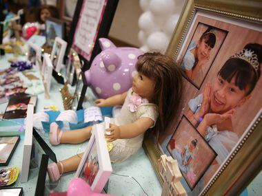 Pictures a momentos line a memory table during a memorial service and viewing of 12-year-old...