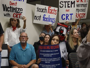 Parents fill the room at Fort Worth Independent School District's meeting in Fort Worth, Tuesday, Dec. 14, 2021. Parents rallied with signs protesting the teaching of critical race theory and asking Superintendent Kent Scribner to resign.