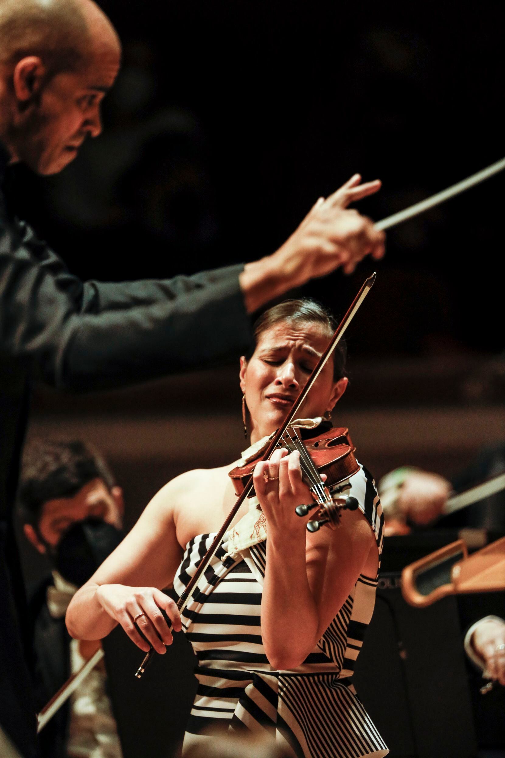 Violinist Elena Urioste plays while Kevin John Edusei conducts the Dallas Symphony Orchestra...