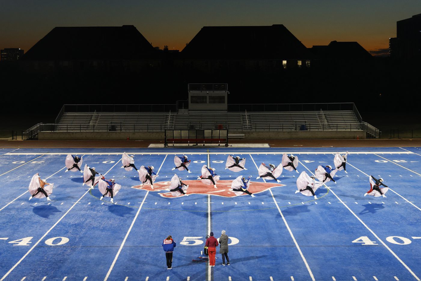 As sunlight appears on the horizon, Parish High School Rosettes drill team take part in...
