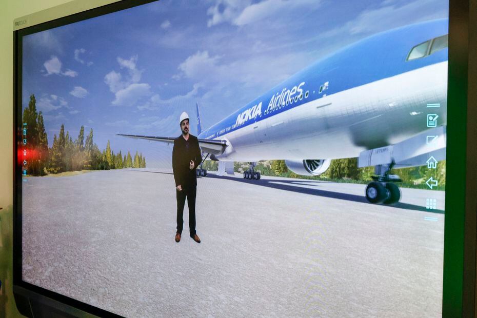 Ali Emam, Nokia's head of demo digital customer journey, demonstrates how green screen...