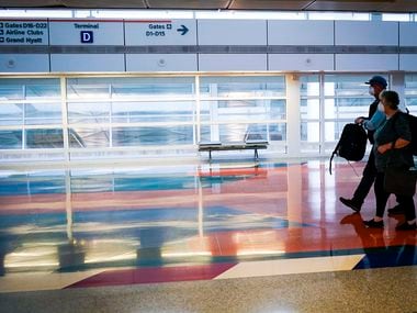 Passengers wearing face masks due to coronavirus exit the Skylink people mover at Dallas Fort Worth International Airport.