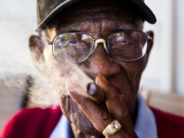 Richard Overton, 111, smokes a cigar on his front porch on May 25, 2017, in Austin. Overton...
