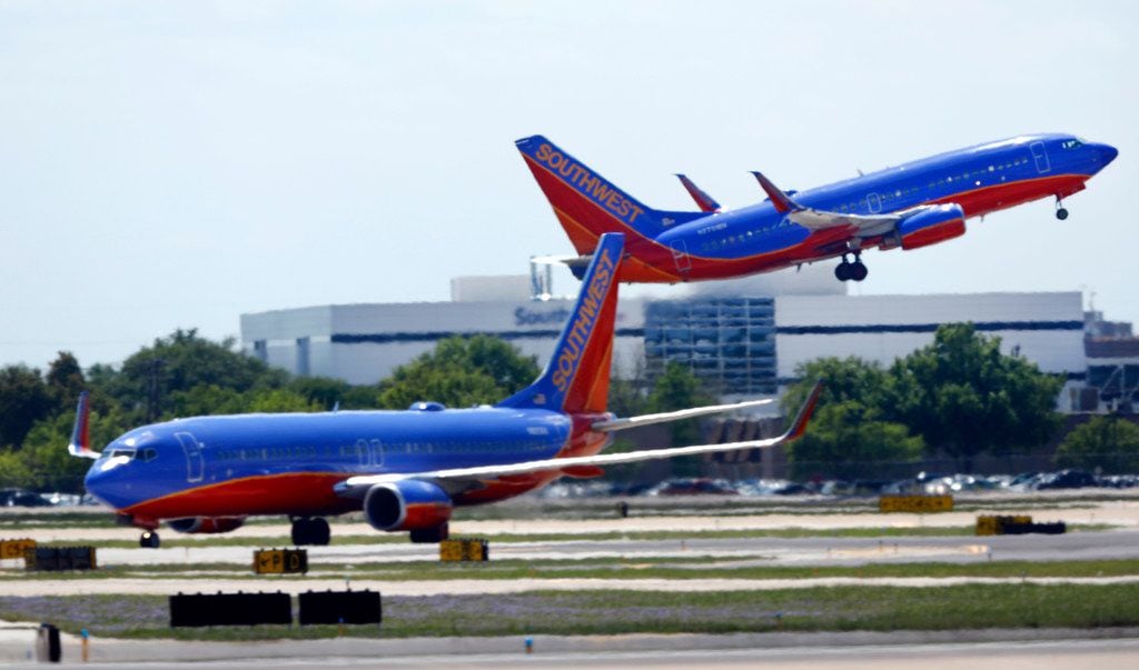 A Southwest Airlines jet takes off in front of company headquarters at Dallas Love Field.