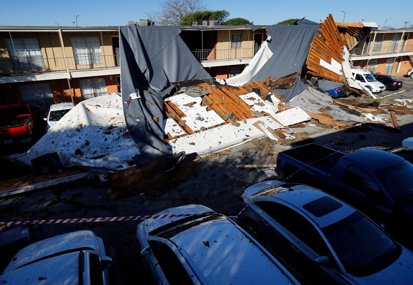 The roof of a Waterdance Apartments building was peeled off by a tornado-warned storm Tuesday night and landed on residents cars in the parking lot. Damage also occurred at The Mirage Apartments along Pioneer Parkway in Arlington, Wednesday, November 24, 2020.