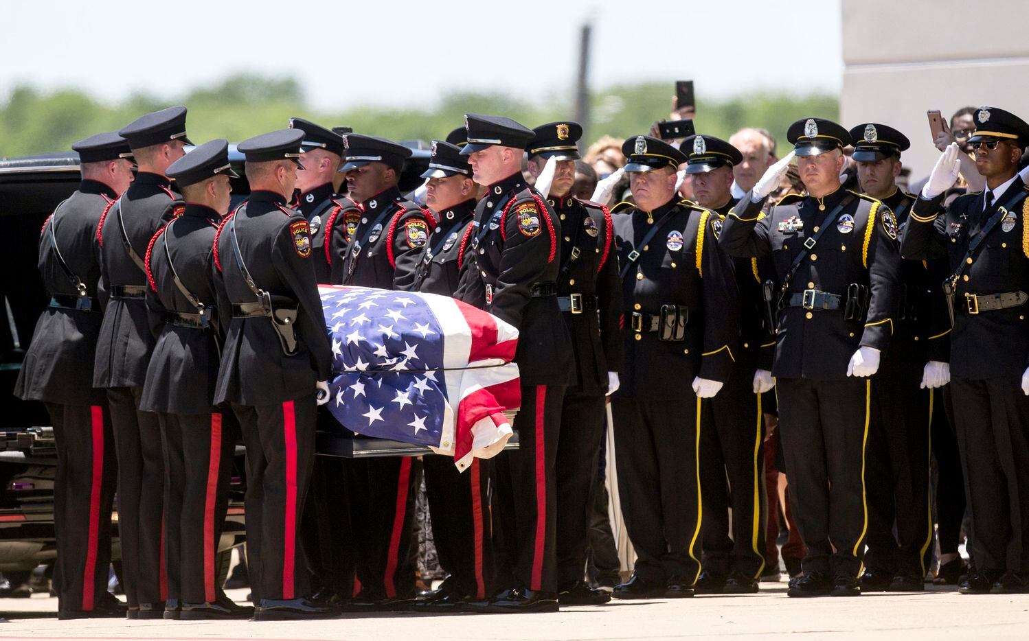 Honor guard members carry the casket Grand Prairie Officer A.J. Castaneda during funeral...