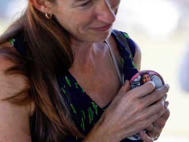 Amy, wife of Democratic gubernatorial candidate Beto O'Rourke puts on a badge dedicated to...