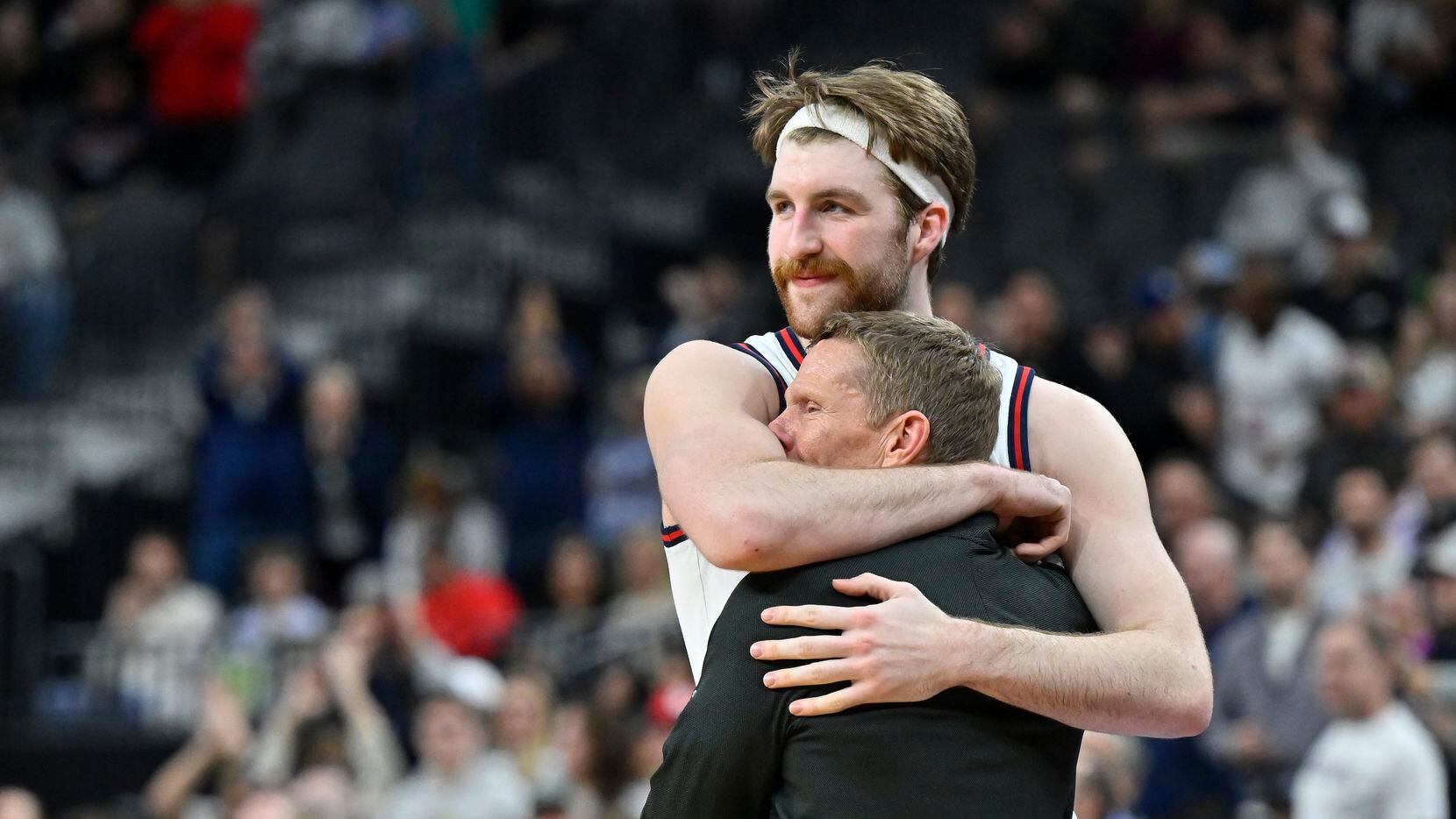 Gonzaga forward Drew Timme hugs head coach Mark Few while checking out of the game during...