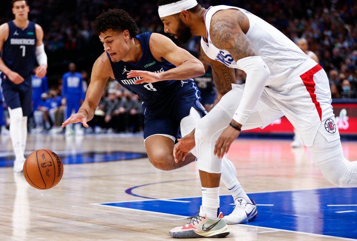 Dallas Mavericks forward George King (8) and LA Clippers forward Marcus Morris Sr. chase after a loose ball during the first half of an NBA basketball game in Dallas, Saturday, February 12, 2022. 