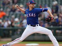 Texas Rangers starting pitcher Jacob deGrom delivers during the first inning of a spring...