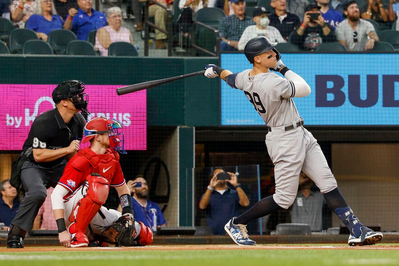 New York Yankees right fielder Aaron Judge (99) hits a home run to left field off Texas...